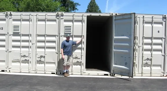 Owner at open container door showing the full 40-foot length